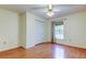 Comfortable bedroom featuring hardwood floors, a window, and a closet providing ample storage space at 17631 Grove View Dr, Lutz, FL 33549