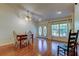 Dining area featuring hardwood floors, a chandelier, and a window providing natural light at 17631 Grove View Dr, Lutz, FL 33549