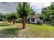 Charming home with a well-manicured lawn and mature trees along a quiet street at 17631 Grove View Dr, Lutz, FL 33549