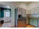 The kitchen shows stainless steel refrigerator and muted green cabinets with granite countertops at 17631 Grove View Dr, Lutz, FL 33549