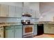 Shows kitchen with stainless steel oven, granite countertops and white subway tile backsplash at 17631 Grove View Dr, Lutz, FL 33549