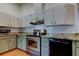 Spacious kitchen with stainless steel appliances, granite countertops, and tiled backsplash at 17631 Grove View Dr, Lutz, FL 33549