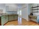 Well-lit kitchen with green and white cabinets and a full view of the pantry at 17631 Grove View Dr, Lutz, FL 33549