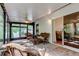 Relaxing screened lanai with wicker furniture and a view of the backyard at 17631 Grove View Dr, Lutz, FL 33549