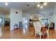 Open-concept living and dining area with wood floors and direct views of the fireplace at 17631 Grove View Dr, Lutz, FL 33549