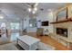 Cozy living room featuring a stone fireplace, hardwood floors, and ample seating at 17631 Grove View Dr, Lutz, FL 33549