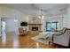 Shows spacious living room with stone fireplace, wood mantle and ceiling fan at 17631 Grove View Dr, Lutz, FL 33549