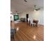 Open-concept living room with wood floors, a dining area, and backyard access at 17631 Grove View Dr, Lutz, FL 33549
