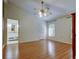 Bright, spacious main bedroom with wood floors, ceiling fan, and an en-suite bathroom at 17631 Grove View Dr, Lutz, FL 33549
