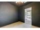 A view of a dark walled room leading to a bright sun room, offering contrasting atmospheres at 17631 Grove View Dr, Lutz, FL 33549