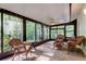 Inviting sunroom featuring wicker furniture and large windows offering natural light and views at 17631 Grove View Dr, Lutz, FL 33549
