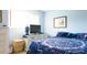 Bedroom with white dresser, television and large window at 1851 Bough Ave # A, Clearwater, FL 33760
