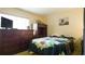 Bedroom with television and dark wood furniture at 1851 Bough Ave # A, Clearwater, FL 33760