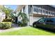 Two story home showing the garage, lush landscaping, and an inviting outdoor space at 1851 Bough Ave # A, Clearwater, FL 33760