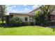 Beautifully landscaped home featuring lush lawn, manicured shrubbery, and inviting curb appeal at 1851 Bough Ave # A, Clearwater, FL 33760