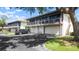 Two-story home with well-maintained garages and a clean driveway, showcasing neat curb appeal at 1851 Bough Ave # A, Clearwater, FL 33760