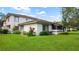 Well maintained two-story home with a green lawn, tasteful landscaping, and neutral color palette at 1851 Bough Ave # A, Clearwater, FL 33760