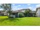 Lush lawn and landscaping surround the neutral-colored home, creating a serene atmosphere at 1851 Bough Ave # A, Clearwater, FL 33760