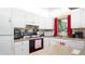 Bright kitchen features white appliances, ample counter space and a window at 1851 Bough Ave # A, Clearwater, FL 33760