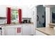 Bright kitchen with white cabinets, appliances and a window at 1851 Bough Ave # A, Clearwater, FL 33760