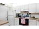 Cozy kitchen featuring white appliances, cabinets and lots of counter space at 1851 Bough Ave # A, Clearwater, FL 33760