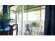 View of screened patio with table and chairs and plants at 1851 Bough Ave # A, Clearwater, FL 33760