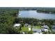 Aerial view showcasing the property's waterfront location and lush landscaping surrounding the lake at 19209 Crooked Ln, Lutz, FL 33548