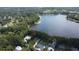 Stunning aerial view of waterfront property with lake access and lush green landscaping at 19209 Crooked Ln, Lutz, FL 33548