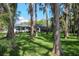 Firepit and Adirondack chairs nestled under mature trees, perfect for entertaining at 19209 Crooked Ln, Lutz, FL 33548