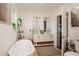 Bright bathroom featuring a standalone tub, double vanity, and a separate toilet area at 19209 Crooked Ln, Lutz, FL 33548