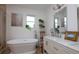 Modern bathroom featuring a standalone tub, double vanity, and plenty of natural light at 19209 Crooked Ln, Lutz, FL 33548
