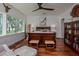 Bedroom with wooden furniture, scenic backyard views, and a bright open space at 19209 Crooked Ln, Lutz, FL 33548