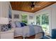 Cozy bedroom with bright blue decorations and a large window overlooking a vibrant backyard at 19209 Crooked Ln, Lutz, FL 33548