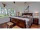 Charming bedroom featuring a large window with lake views, offering a tranquil retreat at 19209 Crooked Ln, Lutz, FL 33548