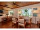 Bright dining area featuring hardwood floors, a large window, and comfortable seating at 19209 Crooked Ln, Lutz, FL 33548