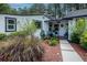 Inviting front entrance with decorative landscaping and a charming porch area at 19209 Crooked Ln, Lutz, FL 33548