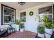 Charming front porch with brick flooring, decorative plants, and stylish seating at 19209 Crooked Ln, Lutz, FL 33548