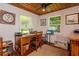 Comfortable home office with wood-paneled ceiling, desk, and bright natural light at 19209 Crooked Ln, Lutz, FL 33548