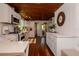 Bright kitchen with white cabinetry, modern appliances, and beautiful wood floors for a modern rustic appeal at 19209 Crooked Ln, Lutz, FL 33548