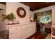 Bright kitchen featuring white cabinetry, marble counters, and a view of the living room with a fireplace at 19209 Crooked Ln, Lutz, FL 33548