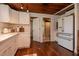 Well-lit kitchen with white cabinets, modern appliances, and hardwood floors at 19209 Crooked Ln, Lutz, FL 33548