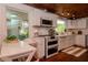 Well-lit kitchen featuring stainless steel appliances, white cabinetry, and view to the outdoors at 19209 Crooked Ln, Lutz, FL 33548