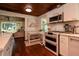 Modern kitchen with an open design, stainless appliances, and a breakfast table with seating at 19209 Crooked Ln, Lutz, FL 33548