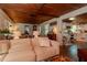 Inviting living room seamlessly connects to the kitchen with matching wood ceilings throughout at 19209 Crooked Ln, Lutz, FL 33548
