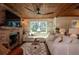 Bright living room with a brick fireplace, wooden ceiling, and comfortable, neutral-toned sectional sofa at 19209 Crooked Ln, Lutz, FL 33548