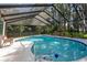Sparkling screened-in pool surrounded by a large deck and mature landscaping at 19209 Crooked Ln, Lutz, FL 33548