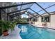 Sparkling screened-in pool surrounded by a large deck and lush landscaping at 19209 Crooked Ln, Lutz, FL 33548