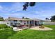 The backyard includes a covered patio and a brick fire pit perfect for outdoor entertaining and relaxation at 206 Hillcrest Dr, Safety Harbor, FL 34695