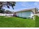 The spacious backyard features green grass, a patio, and a white fence at 206 Hillcrest Dr, Safety Harbor, FL 34695