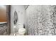 Bathroom features wood cabinets, granite counters, and patterned shower curtain at 206 Hillcrest Dr, Safety Harbor, FL 34695